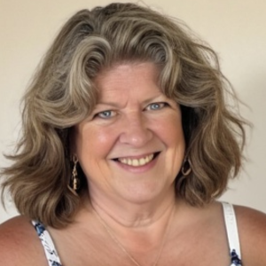 Kat B smiling near the ocean, symbolizing calm confidence, healing, and new beginnings at any age.